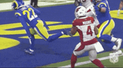 A Football Player With The Number 4 On His Jersey Is Running On The Field . GIF