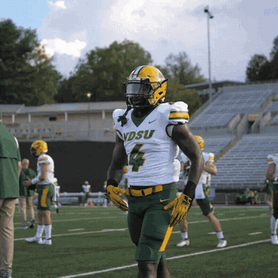 A Football Player With The Number 4 On His Jersey Stands On A Field GIF