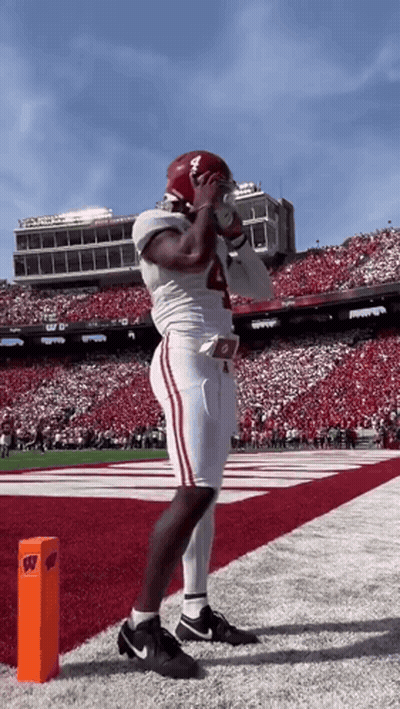 A Football Player With The Number 4 On His Jersey Stands On The Field GIF