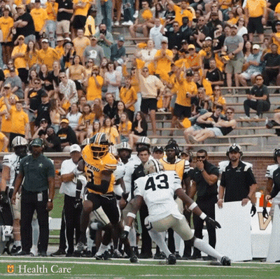 A Football Player With The Number 43 On His Jersey Jumps In The Air GIF