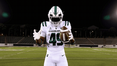A Football Player With The Number 49 On His Jersey Holds A Football GIF