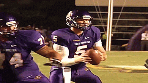 A Football Player With The Number 5 On His Jersey Is Being Tackled GIF