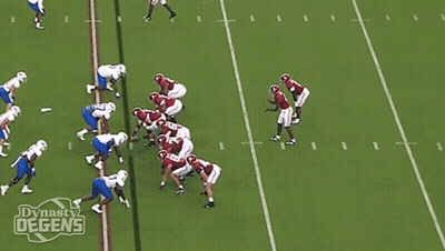 A Football Player With The Number 5 On His Jersey Is Being Tackled GIF