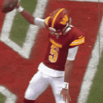 A Football Player With The Number 5 On His Jersey Is Throwing The Ball GIF