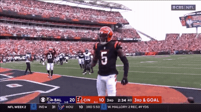 A Football Player With The Number 5 On His Jersey Stands On The Field GIF