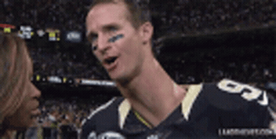 A Football Player With The Number 5 On His Jersey Talking To A Woman GIF