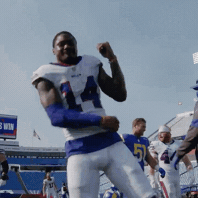 A Football Player With The Number 51 On His Jersey Is Dancing GIF