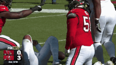 A Football Player With The Number 51 On His Jersey Is Laying On The Field GIF