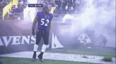 A Football Player With The Number 52 On His Jersey Is Walking On The Field GIF