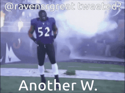 A Football Player With The Number 52 On His Jersey Stands On A Field GIF