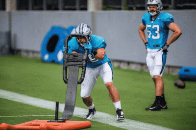 A Football Player With The Number 53 On His Jersey Is Being Pushed By A Sled GIF