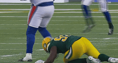 A Football Player With The Number 55 On His Jersey Is Laying On The Field GIF