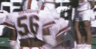 A Football Player With The Number 56 On His Jersey Is Running On A Field . GIF