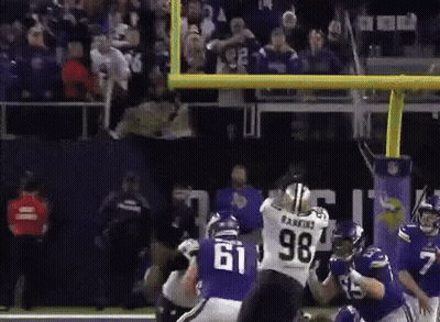 A Football Player With The Number 61 On His Jersey Is Being Tackled By Another Player GIF
