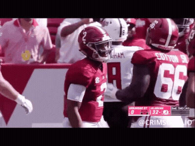 A Football Player With The Number 66 On His Jersey Talks To Another Player GIF