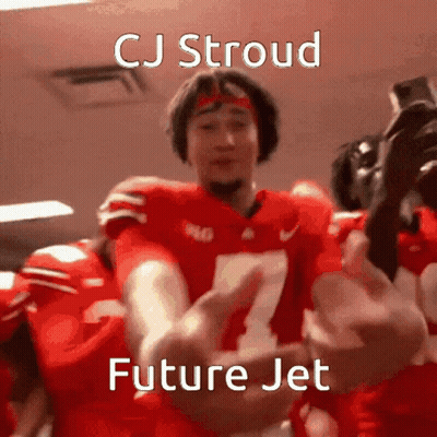 A Football Player With The Number 7 On His Jersey Is Being Hugged By His Teammates . GIF