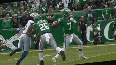 A Football Player With The Number 7 On His Jersey Is Being Tackled By Another Player GIF