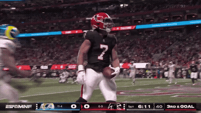 A Football Player With The Number 7 On His Jersey Is Holding A Football GIF