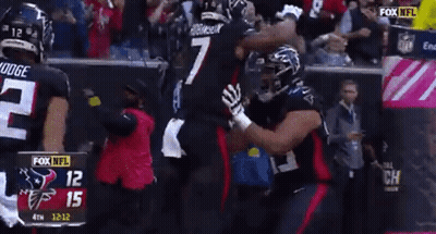 A Football Player With The Number 7 On His Jersey Is Hugging Another Player GIF