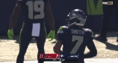 A Football Player With The Number 7 On His Jersey Is Running With The Ball GIF
