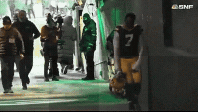 A Football Player With The Number 7 On His Jersey Walks Through A Tunnel GIF