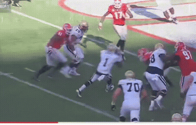 A Football Player With The Number 70 On His Jersey Is Jumping In The Air GIF