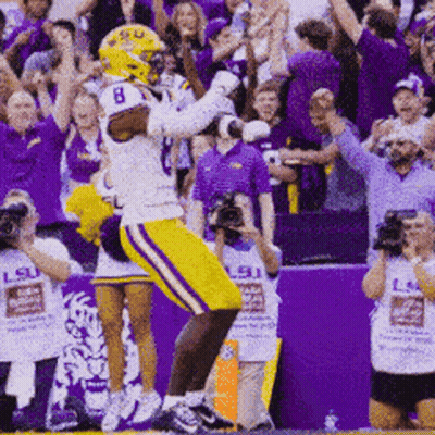 A Football Player With The Number 8 On His Helmet Celebrates GIF