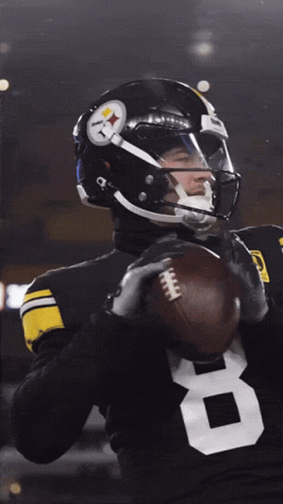 A Football Player With The Number 8 On His Jersey Is Holding A Football GIF