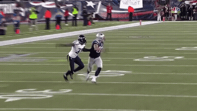 A Football Player With The Number 8 On His Jersey Is Running On A Field GIF