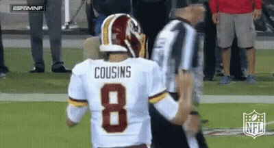 A Football Player With The Number 8 On His Jersey Is Talking To A Referee . GIF