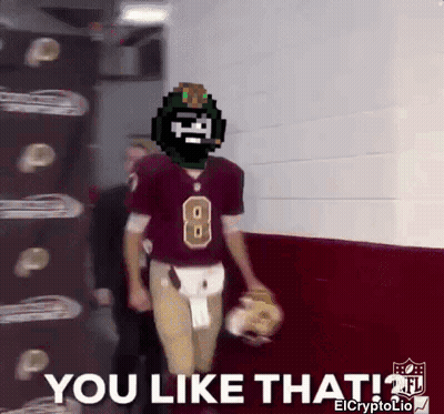 A Football Player With The Number 8 On His Jersey Is Walking Down A Hallway GIF