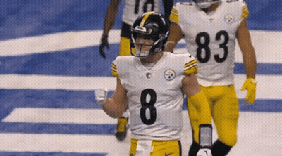 A Football Player With The Number 8 On His Jersey Is Walking On The Field GIF