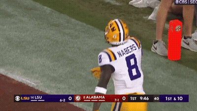 A Football Player With The Number 8 On His Jersey Stands On The Field GIF