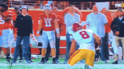 A Football Player With The Number 8 On His Jersey Stands On The Field GIF