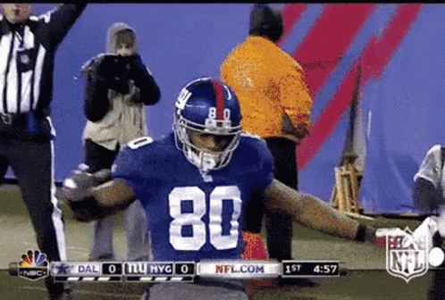 A Football Player With The Number 80 On His Jersey Is Celebrating GIF