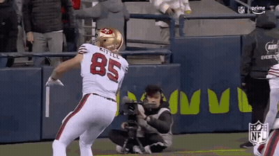 A Football Player With The Number 85 On His Back Is Standing On A Field . GIF