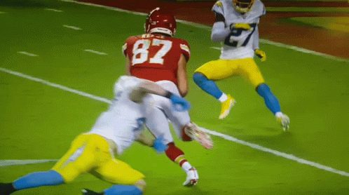 A Football Player With The Number 87 On His Jersey Is Being Tackled GIF