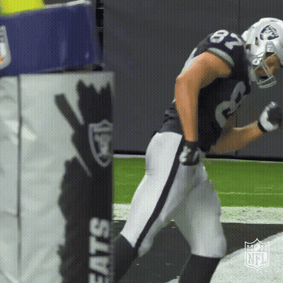 A Football Player With The Number 87 On His Jersey Is Running On The Field GIF