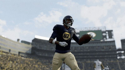 A Football Player With The Number 87 On His Jersey Is Throwing A Ball GIF