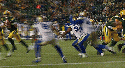 A Football Player With The Number 9 On His Jersey Is Being Tackled By Another Player GIF