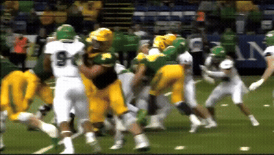 A Football Player With The Number 9 On His Jersey Is Being Tackled GIF