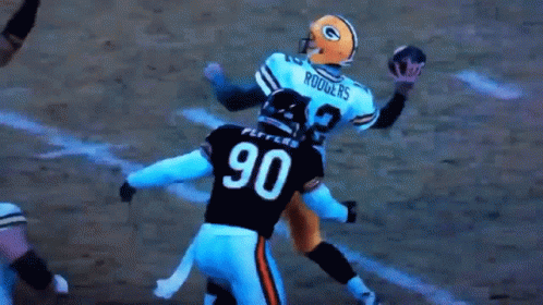 A Football Player With The Number 90 On His Jersey Is Being Tackled By Another Player GIF