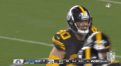 A Football Player With The Number 90 On His Jersey Is Dancing On The Field GIF