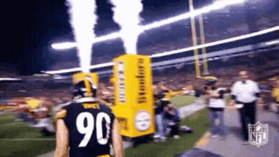 A Football Player With The Number 90 On His Jersey Is Walking On The Field GIF