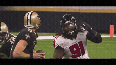 A Football Player With The Number 91 On His Jersey Is Being Tackled By Another Player GIF