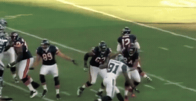 A Football Player With The Number 91 On His Jersey Is Being Tackled By Another Player GIF
