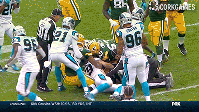 A Football Player With The Number 96 On His Back Is Being Tackled GIF