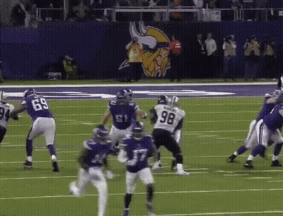 A Football Player With The Number 98 On His Jersey Is Running On The Field GIF