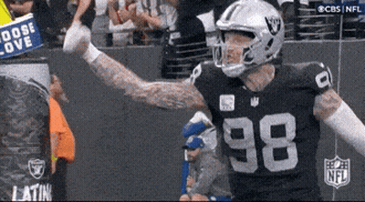 A Football Player With The Number 98 On His Jersey Stands In Front Of A Crowd GIF