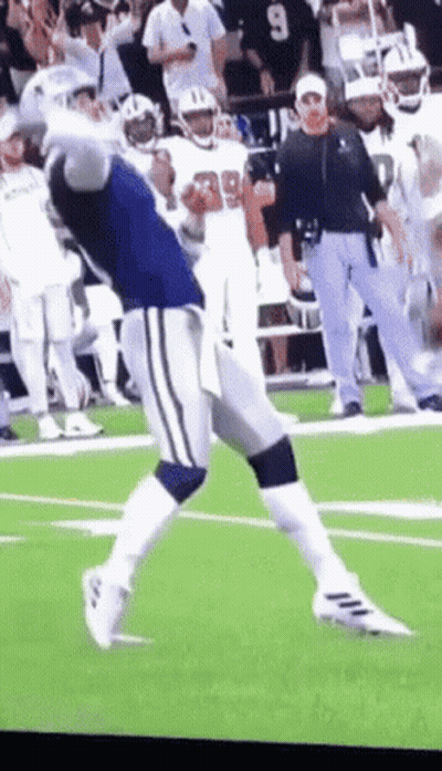 A Football Player With The Number 99 On His Jersey Is Running On The Field GIF